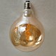 LED крушка G125 със символ Сол ключ - Е27 - 4W - златно стъкло LED крушка G125 със символ Сол ключ - Е27 - 4W - златно стъкло